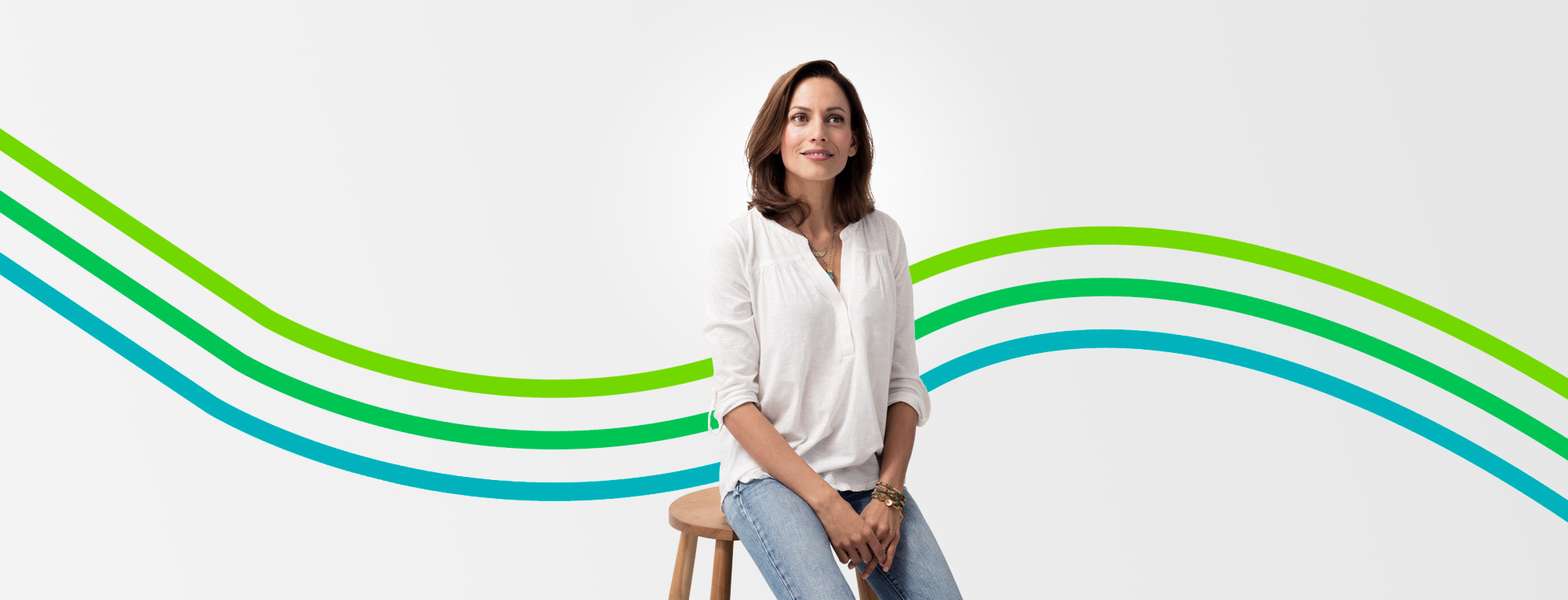 Smiling woman in white shirt featured in an article about things to consider in retiring early